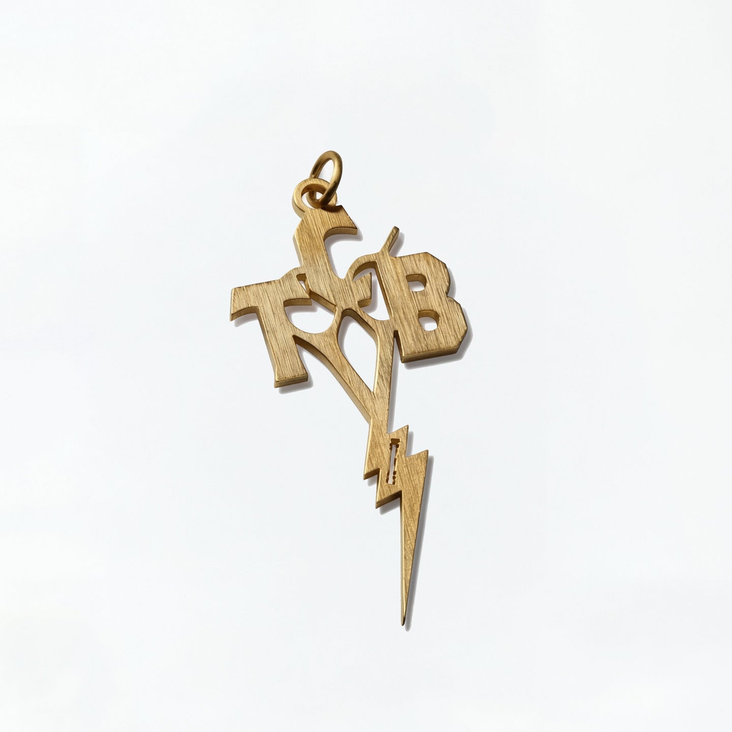 Gold pendant with 'T&B' initials and a lightning bolt on a white background